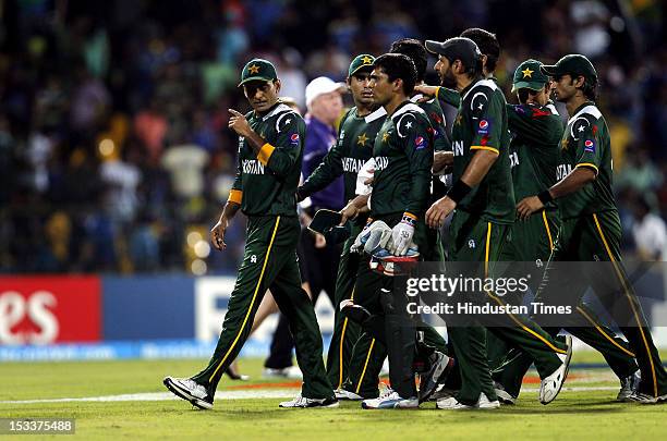 Captain Mohammad of Pakistan and his team leave the ground after Sri Lanka inning during the ICC T20 World Cup cricket semi final match between Sri...