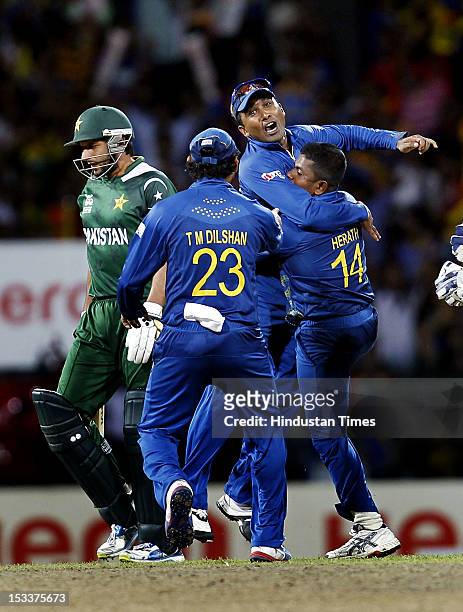 Rangana Herath, Tillakaratne Dilshan and Captain Mahela Jayawardene of Sri Lanka celebrate after the dismissal of batsman Shahid Afridi of Pakistan...