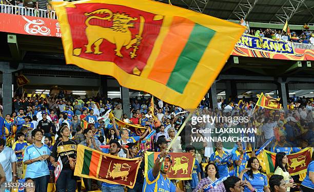 Sri Lanka's fans cheer after their team's victory in the ICC Twenty20 Cricket World Cup's semi-final match between Sri Lanka and Pakistan at the R....