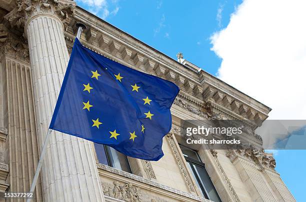 european union flag flying outside brussels bourse - bourse stock pictures, royalty-free photos & images