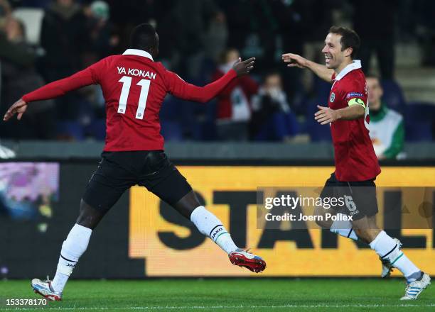 Didier Ya Konan of Hannover celebrates with his team mate Steven Cherundolo after scoring his team's second goal during the UEFA Europa League Group...