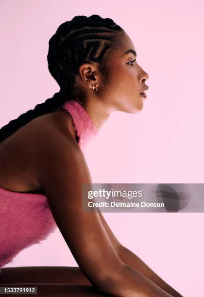 woman sitting looking to the side. stock photo - pink belt stock pictures, royalty-free photos & images