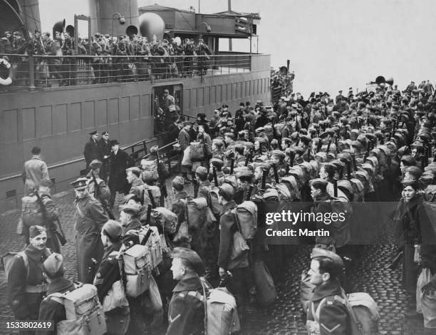 Soldiers from the 2nd Canadian Infantry Brigade, 1st Canadian Infantry Division of the Canadian Active Service Force disembark and stand at parade...