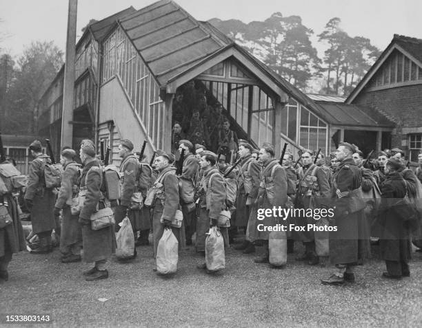 Soldiers from the 1st Canadian Infantry Division of the Canadian Active Service Force disembark from their train and stand at parade after arriving...