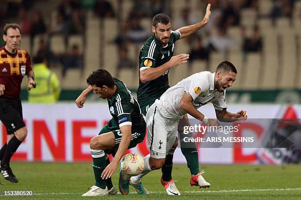 Tottenham's Clint Dempsey vies for the ball with players of Panathinaikos during the group stage Europa League football game between Panathinaikos...