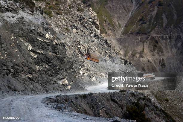 Trucks carry supplies to Ladakh on a treacherous road of Zojila Pass before the foundation stone-laying ceremony for a tunnel on the Srinagar-Leh...