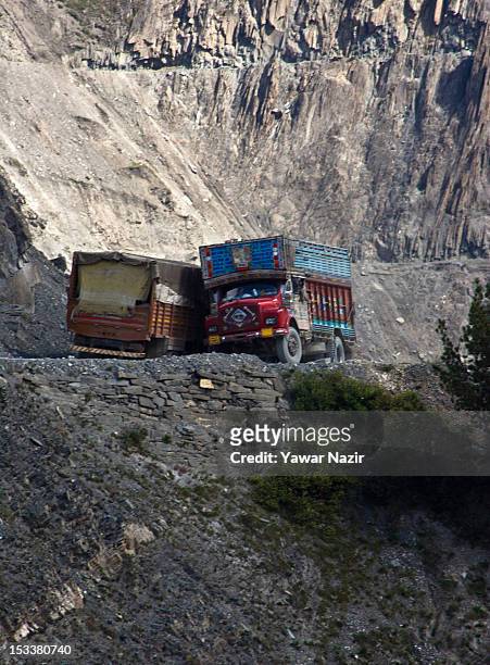 Trucks carry supplies to Ladakh on a treacherous road of Zojila Pass before the foundation stone-laying ceremony for a tunnel on the Srinagar-Leh...