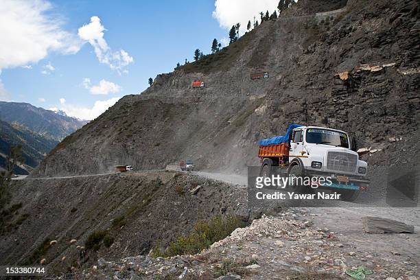 Trucks carry supplies to Ladakh on a treacherous road of Zojila Pass before the foundation stone-laying ceremony for a tunnel on the Srinagar-Leh...