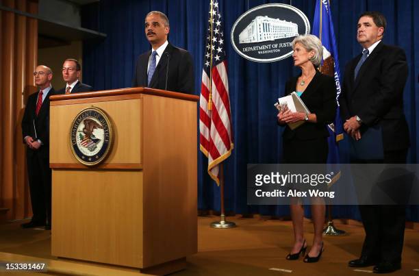 Attorney General Eric Holder speaks as Health and Human Services Secretary Kathleen Sebelius , Assistant Attorney General Lanny Breuer of the...