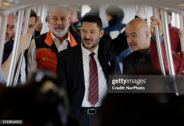 In suit and tie, Marti Batres, head of the Mexico City government, accompanied by Guillermo Calderon , Sistema de Transporte Colectivo Metro; Jesus...