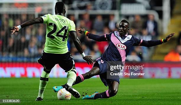 Newcastle player Cheick Tiote challenges Ludovic Sane during the UEFA Europa League match between Newcastle United and FC Girondins de Bordeaux at...