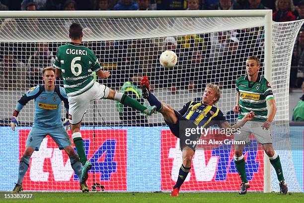 Dirk Kuyt of Fenerbahce is challenged by goalkeeper Marc-Andre ter Stegen, Tolga Cigerci and Filip Daems of Moenchengladbach during the UEFA Europa...