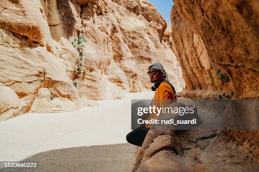 An Asian tourist in the hidden city of Petra, Jordan