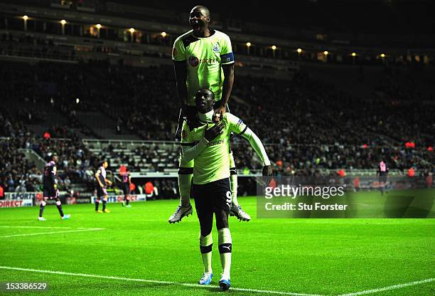 Newcastle player Papiss Cisse and Shola Ameobi celebrate the third Newcastle goal during the UEFA Europa League match between Newcastle United and FC...