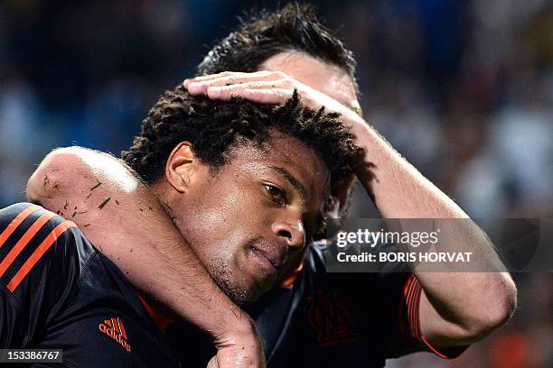 Marseille's French forward Loic Remy is congratulated by a teammate after scoring during the UEFA Europa League Group C football match Olympique...