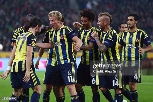 Dirk Kuyt of Fenerbahce celebrates his team's third goal with team mate Goekhan Goenuel and others during the UEFA Europa League group C match...