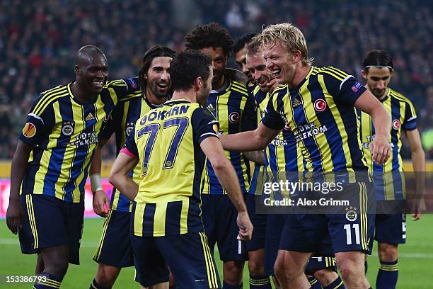 Dirk Kuyt of Fenerbahce celebrates his team's third goal with team mate Goekhan Goenuel and others during the UEFA Europa League group C match...