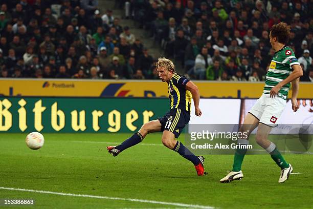 Dirk Kuyt of Fenerbahce scores his team's third goal against Roel Brouwers of Moenchengladbach during the UEFA Europa League group C match between...