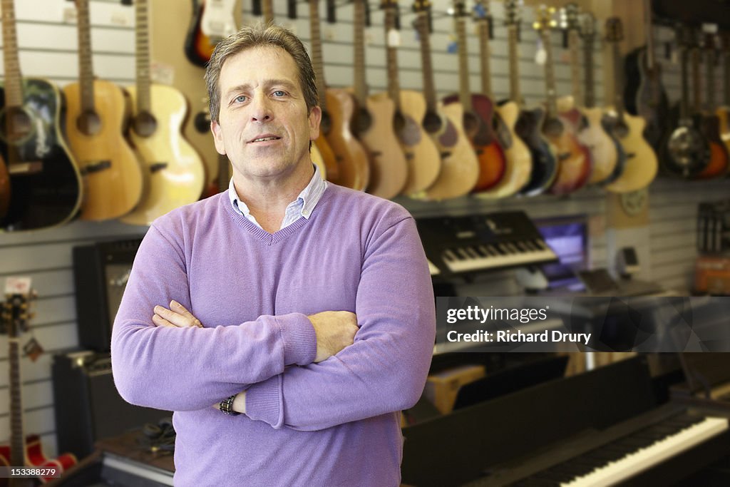 Owner of music shop in his store
