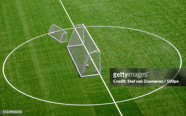 high angle view of soccer field - soccer goal stock-fotos und bilder