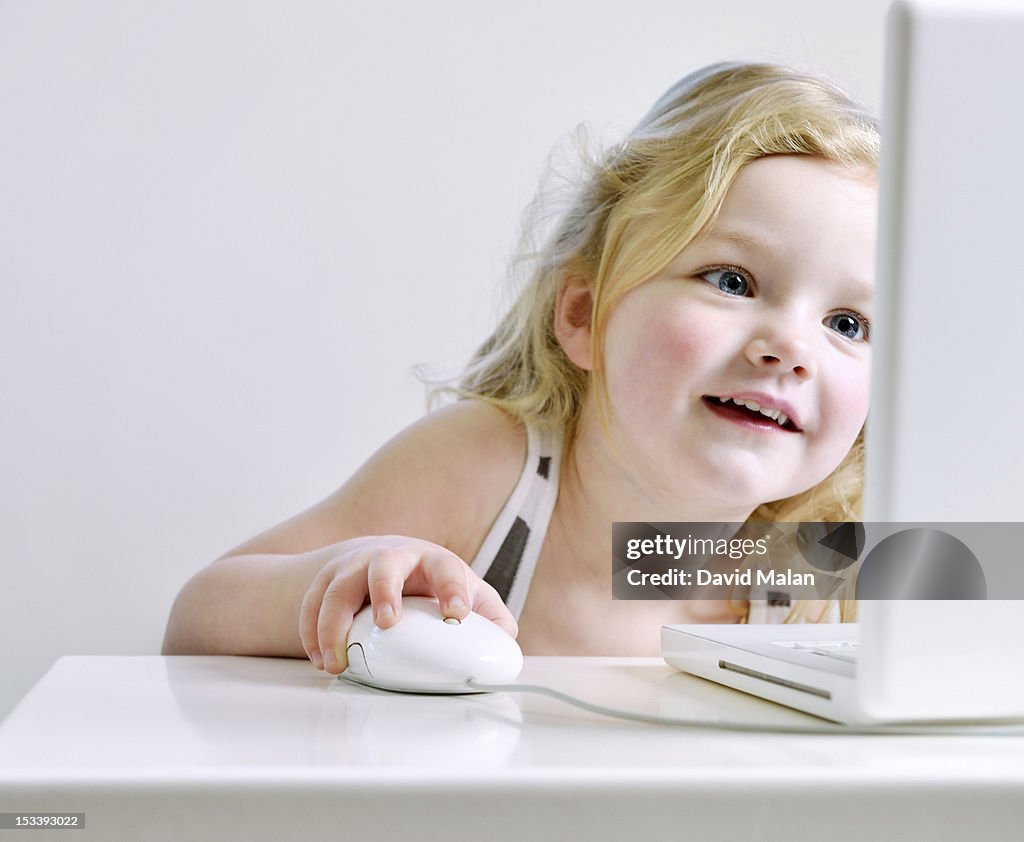 Young girl enjoying using a computer