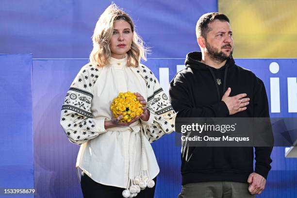 The President of Ukraine, Volodymyr Zelenskyy and the first lady of Ukraine, Olena Zelenska stand together on the stage during the Raising the Flag...