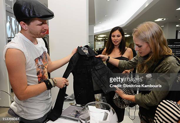 Ryan Watt helps guests at the Marc by Marc Jacobs and People StyleWatch event at Saks Fifth Avenue on October 4, 2012 in New York City.