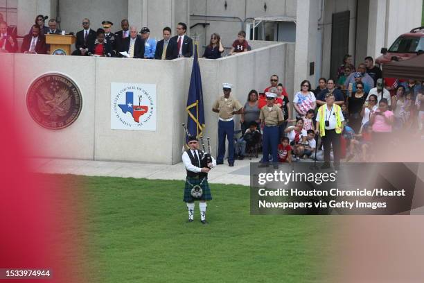 Bagpiper Ian Martin plays "Amazing Grace" during a Memorial Day Service, honoring deceased United States servicemen and women Monday, May 30 in...