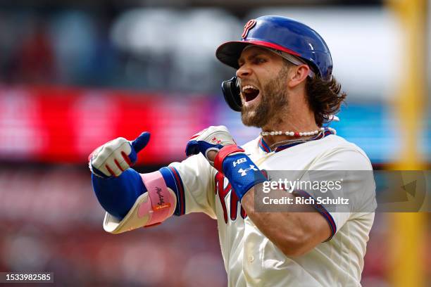 Bryce Harper of the Philadelphia Phillies reacts after he hit an RBI single against the San Diego Padres during the eighth inning of game one of a...
