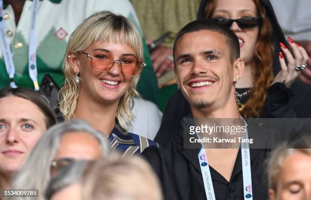 Mia Regan and Romeo Beckham smile as they attend day nine of the Wimbledon Tennis Championships at the All England Lawn Tennis and Croquet Club on...