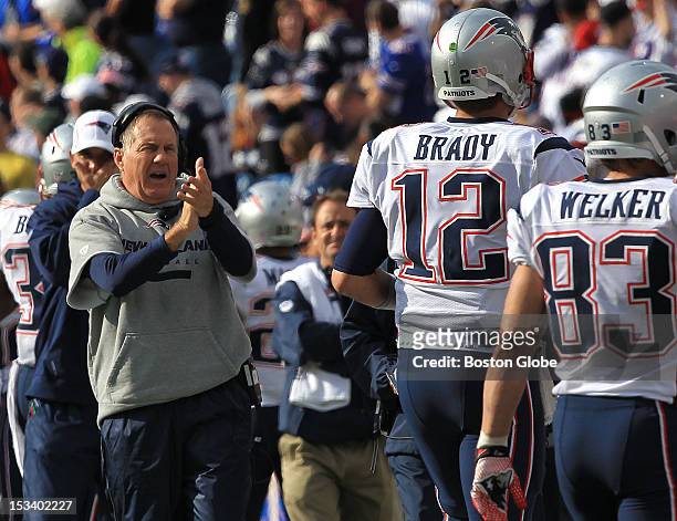 New England Patriots head coach Bill Belichick applauded New England Patriots quarterback Tom Brady after Brady's touchdown pass to New England...