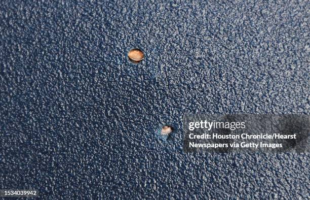 Billy Gibbons, co-owner of Veterans MFG shows the 45 caliber and 40 caliber bullets that was stopped by one of their bullet-proof plates Monday, Aug....