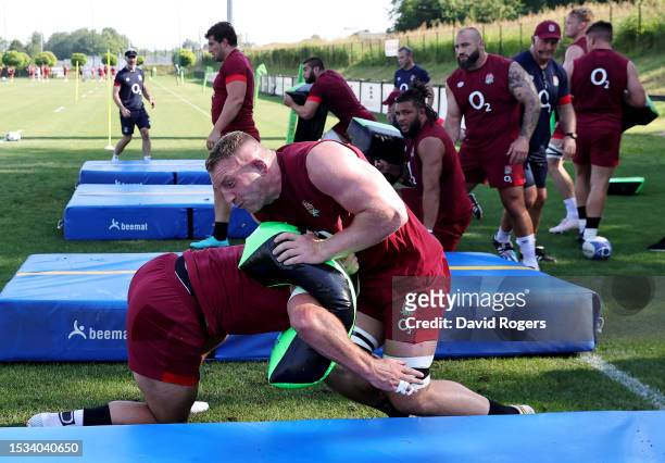 Sam Underhill of England uses a tackle bag with teammates during the England Rugby Training Session at Payanini Center on July 11, 2023 in Verona,...