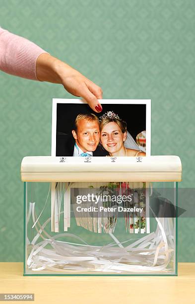 divorced wife shredding wedding photo - divorce stock-fotos und bilder