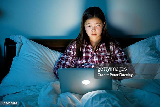 frightened child surfing internet at night - obsessive stockfoto's en -beelden