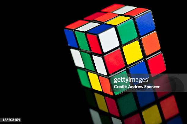 Rubik's Cube toy on black background with reflection.