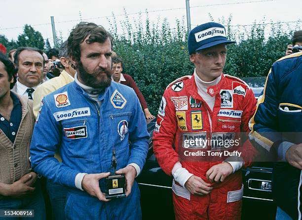 Austrian racing driver Niki Lauda with driver Harald Ertl during the Italian Grand Prix at Monza, 12th September 1976. Ertl helped pull Lauda from...