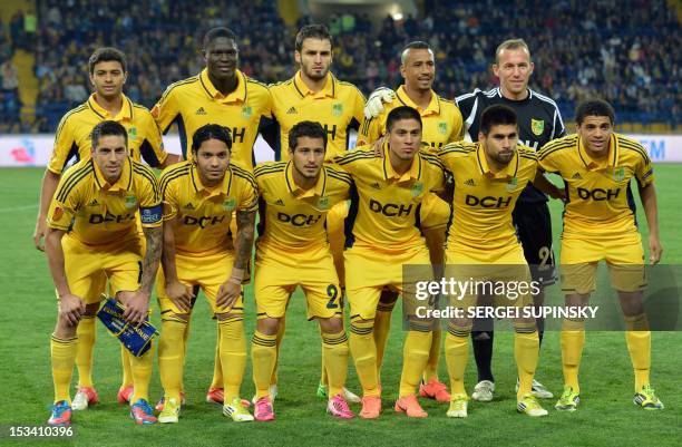 Metalist Kharkiv players, back row, from left, midfielder Cleiton Xavier, midfielder Papa Gueye, defender Cristian Villagra, defender Fininho,...