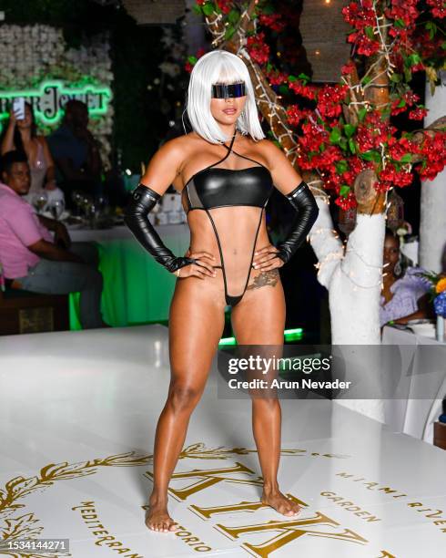 Model walks the runway wearing OMG Swimwear during the VIP Sunset Soiree for Miami Swim Week Powered By Art Hearts Fashion at Kiki on the River on...