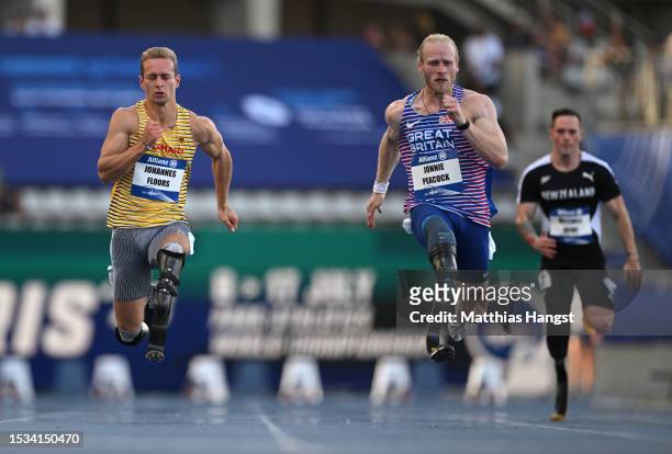 Johannes Floors of Germany and Jonnie Peacock of Great Britain compete in Men's 100m T64 Round 1 Heat2 during day four of the Para Athletics World...