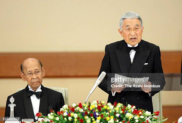 Japanese Emperor Akihito makes a speech while Malaysian King Abdul Halim Mu'adzam Shah listens during the state dinner at the Imperial Palace on...