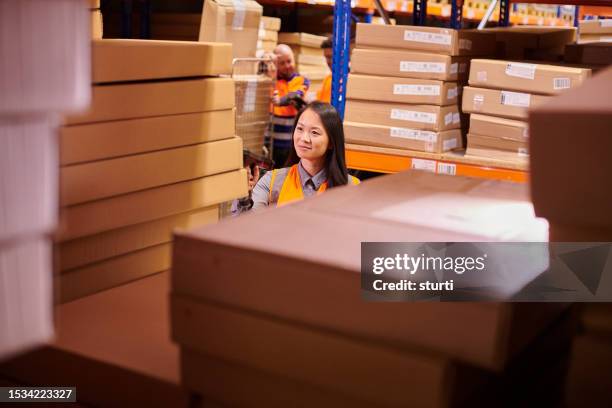 warehouse picker with scanner - asian females stock pictures, royalty-free photos & images