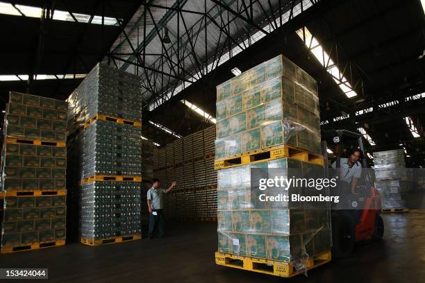 Forklift operator transports cases of Thai Beverage Pcl Chang beer at the company's Beer Thip brewery in Bang Ban, Ayutthaya province, Thailand, on...