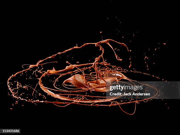 chocolate swirling mid-air - chocolate swirls foto e immagini stock