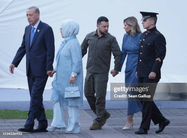 Ukrainian President Volodomyr Zelensky and his wife Olena Zelenska walk with Turkish President Recep Tayyip Erdogan and his wife Emine Erdogan as...