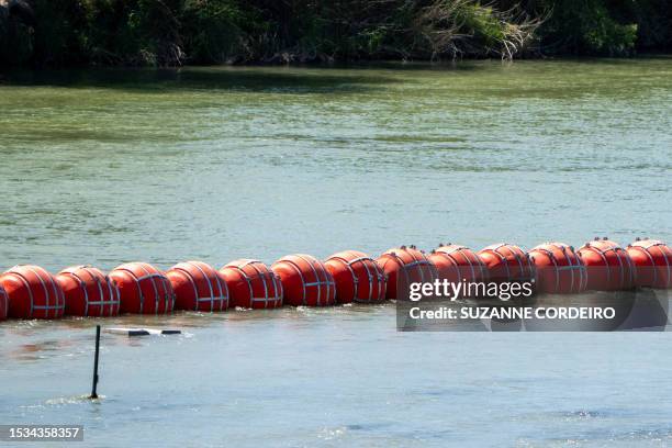 Buoys are placed on the water along the Rio Grande border with Mexico in Eagle Pass, Texas, on July 15 to prevent migrants from entering the US. The...