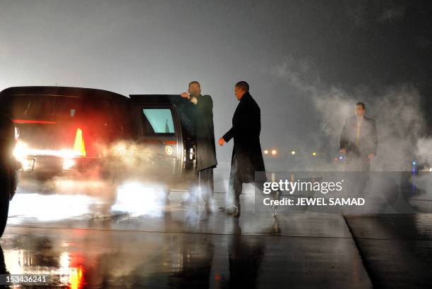 President Barack Obama walks to his car upon arriving in Romules, Michigan, on January 26, 2012. AFP Photo/Jewel Samad
