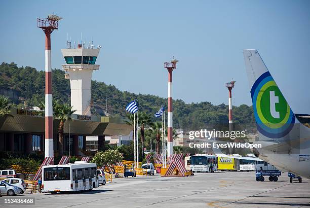 Runway, aircrafts and buses at Diagoras Airport on August 23, 2012 in Rhodes, Greece . Rhodes is the largest of the Greek Dodecanes Islands.