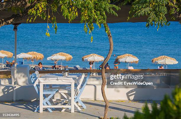 White and blue chairs and table of the traditional seafood tavern Paralia next to the beach of Kiotari on August 23, 2012 in Rhodes, Greece . Rhodes...