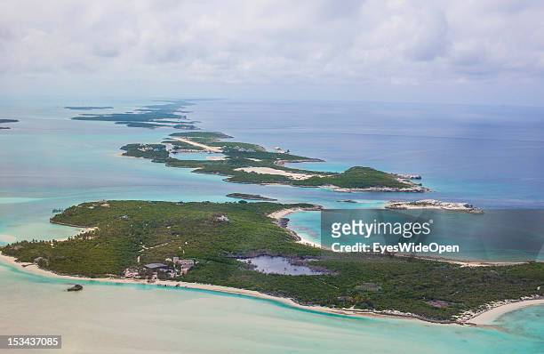 Aerial view of the small atolls, lagoon islands and turqouis waters of the carribean sea of the Exumas seen from an airplane on June 15, 2012 in The...
